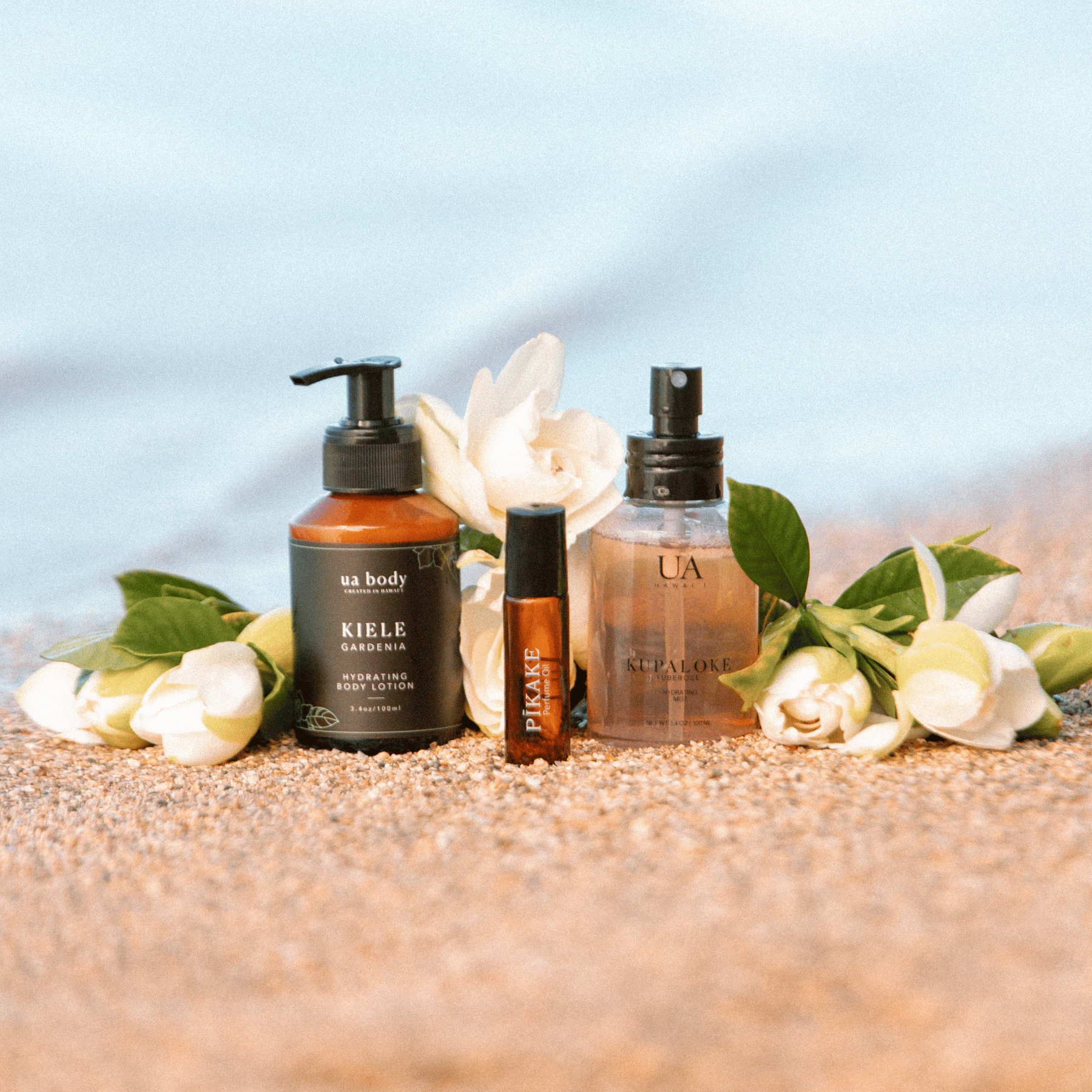 Hawaiian body care and skin care products on beach with flowers